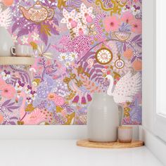 the wallpaper in this room is colorful and has many flowers on it, as well as vases