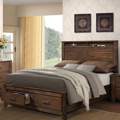 a bedroom scene with focus on the bed and drawers in front of the headboard