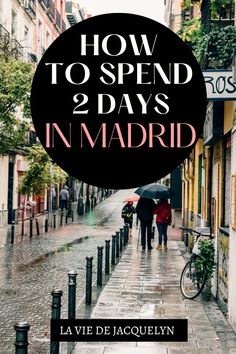 two people walking down the street with umbrellas in hand and text overlaying how to spend 2 days in madrid