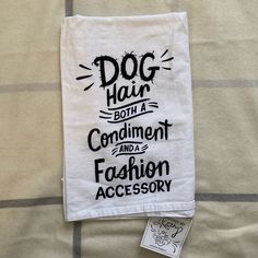 a white towel with the words dog hair on it and a tag attached to it