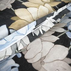 closeup of the fabric with flowers on it and an arrow sticking out of it