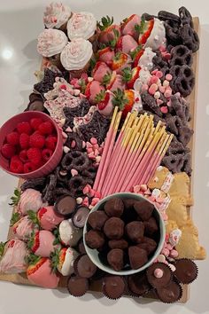 a platter filled with lots of different types of desserts and pastries on top of a table