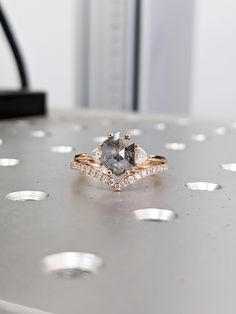 a diamond ring sitting on top of a table