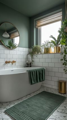 Modern bathroom featuring white and green tiles, a large round mirror, plants in a vase, and a green velvet towel. Grey Bathroom With Green Accents, Green Wall Tiles Bathroom, Master Bath Green, Green Black And White Bathroom, Grey And Green Bathroom Ideas, Grey And Green Bathroom, Bathroom Green Tiles, Bathroom Grey Tiles, White And Green Bathroom