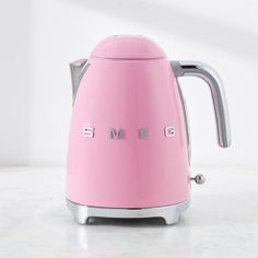 a pink toaster sitting on top of a white counter