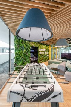 an indoor foosball table in the middle of a living room