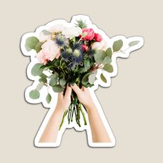 a person holding a bouquet of flowers in front of a sticker on a wall