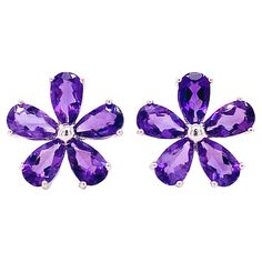 These amethyst flower earrings are perfect for anyone that loves bright and vibrant floral designs. The perfectly cut pear shaped amethysts sparkle brightly as they circle the center bright sphere of silver to form a five petal flower! The details for these gorgeous earrings are listed below: 1 Set Metal Quality: Sterling silver with a rhodium plating Earring Type: Friction post and push-on friction back Earring Diameter: 11 millimeters Gemstone: Amethyst Gemstone Color: Purple Gemstone Shape: P Five Petal Flower, Amethyst Flower, Petal Flower, Number 10, Star Jewelry, Flower Tops, Earring Type, Amethyst Earrings, Modern Earrings