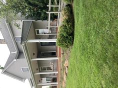 a house with two balconies on the second floor and an upper deck in the back yard