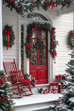 a red rocking chair sitting on top of a porch covered in christmas wreaths