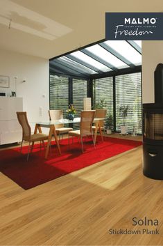 a living room filled with furniture and a fire place in front of a glass wall