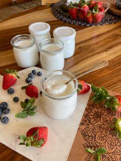 yogurt, strawberries and blueberries on a cutting board