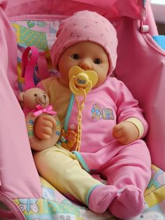 a baby doll with a pacifier in its mouth