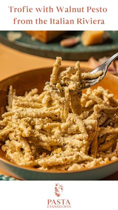 a bowl full of pasta with a fork in it and the words trofie with walnut pesto from the italian rivier