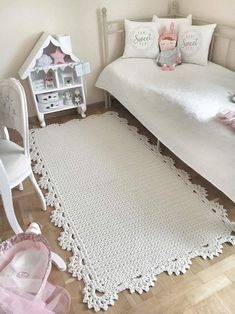 a bedroom with a white bed and pink accessories