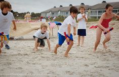 children playing in the sand at the beach