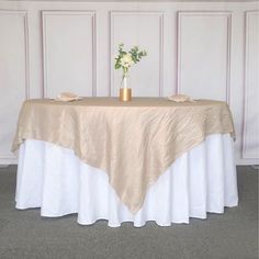 there is a table with a white and gold cloth on it