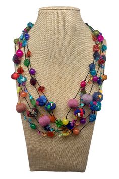 a necklace with multi colored beads on a mannequin