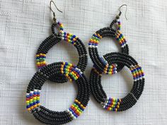 "Black and Multi color Indian style bead dangle earrings, with the small seed beads. They measure 3\" in height and almost 2\" in width. The way the circles are threaded there's a full circle hanging from a circle that's a vertical hoop, so they're perpendicular to each other. Also, please take a look at my storefront at: https://www.etsy.com/shop/FabFinds42?ref=seller-platform-mcnav I have a wide selection of one-of-a-kind items, from clothing and toys to home decor and gift items, and I add ne Black Dangle Beaded Earrings, Multicolor Beaded Earrings With Black Beads For Party, Black Beaded Earrings With Round Beads As Gift, Black Beaded Earrings With Colorful Beads For Gifts, Black Earrings With Colorful Beads, Multicolor Earrings With Black Beads For Gift, Black Dangle Jewelry With Colorful Beads, Traditional Multicolor Earrings With Colorful Beads, Black Jewelry With Dangling Round Beads