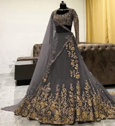 a grey and gold wedding gown on display