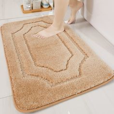 a person standing on top of a bathroom rug