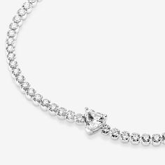 Bring elegance to your outfit with the Sparkling Pavé Tennis Bracelet. Hand-finished in sterling silver, this tennis bracelet is decorated with sparkling clear cubic zirconia. A large central heart-shaped stone punctuates a row of evenly sized pavé. The bracelet includes a lobster clasp for safe closure and can be adjusted to three lengths. Style it with other shimmering Pandora Timeless pieces for a classic look that stands out. - Pandora Sparkling Heart Tennis Bracelet - Sterling silver / Cubic Zirconia / Clear - Sz. 7.1 in Silver Cubic Zirconia Heart Bracelet For Formal Occasions, Formal White Gold Heart Bracelet With Cubic Zirconia, Elegant Cubic Zirconia Heart Cut Tennis Bracelet, Elegant Silver Heart-shaped Tennis Bracelet, Silver Heart Bracelet With Diamond Accents, Silver Diamond Heart Cut Bracelet, Formal White Gold Heart Tennis Bracelet, Heart-shaped White Gold Tennis Bracelet With Cubic Zirconia, White Gold Heart-shaped Cubic Zirconia Tennis Bracelet