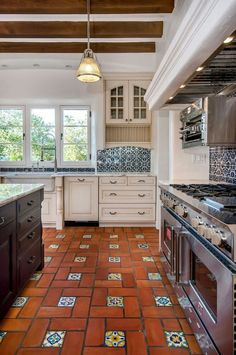 a kitchen with tile flooring and white cabinets