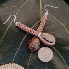 These earrings are one of a kind and gorgeous on. They have been intricately crafted using three strands of very high quality Kahelelani shells woven into a rope pattern, with Hawaiian cowrie shells and puka shells. Each shell has been hand picked from the beaches of Kauai, Hawaii and hand drilled.    Drop Length: 2.5' Inch   Length: 3'  Width: 0.5' These earrings are strung on 40lb' braided nylon line and are on 1/2' inch sterling silver wires.   Earrings will arrive in a gift box with rubber b Traditional Nickel-free Earrings For Beach, Natural Beaded Jewelry For Gifts, Handmade Nature-inspired Dangle Beaded Earrings, Traditional Natural Jewelry For Gifts, Traditional Natural Jewelry As A Gift, Artisan Beach Jewelry Set With Earrings, Adjustable Traditional Earrings For Beach, Traditional Natural Jewelry For Jewelry Making, Traditional Natural Tone Jewelry For Jewelry Making