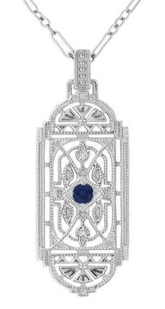 This stunning Art Deco blue sapphire pendant necklace in sterling silver features a vintage heirloom geometric filigree lozenge design, adorned with a nature inspired filigree leaves motif and light scattering millgrain edging for a wonderful finishing touch. At its center is a 0.15 carat royal blue sapphire ( September Birthstone ) in a secure 4 prong bead setting. Measuring approximately 1 3/4 inches high including the bail, by 11/16 inch wide, this beautiful original 1920's design sapphire ne Art Deco Filigree, Light Scattering, Filigree Pendant Necklace, Emerald Necklace Pendant, Silver Necklace Simple, Geometric Pendant Necklace, Ruby Necklace Pendant, Blue Sapphire Pendant, Sapphire Necklace Pendants