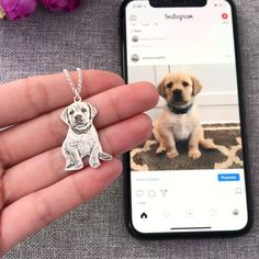 a person holding a cell phone with a dog charm on it