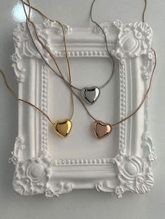 Add a touch of elegance with the beautiful Wendy necklace. Featuring a chubby metallic heart charm sliding along a delicate snake chain, this necklace adds a playful yet chic touch to any outfit. Whether you're dressing up or keeping it casual, this necklace offers style and sophistication for every day. The snake chain design requires extra care to prevent kinks and damage. Additionally, the chubby heart charm is prone to scratches, so please handle with care to maintain its pristine look. Mate Heart-shaped Rose Gold Charm Necklace, Trendy Rose Gold Heart Necklace, Trendy Rose Gold Charm Necklaces For Valentine's Day, Rose Gold Heart Pendant Necklace For Party, Rose Gold Metal Heart Necklace, Rose Gold Heart-shaped Metal Necklace, Heart-shaped Rose Gold Metal Necklace, Trendy Heart Pendant Charm Necklaces For Party, Trendy Rose Gold Heart Charm Necklaces