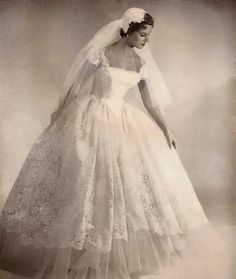 an old photo of a woman in a wedding dress