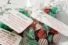 some christmas candy is wrapped in plastic and has tags on them that say holiday kisses