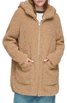 Stay warm in this soft, midweight faux shearling parka featuring an attached hood and patch pockets for cozy-chic style. 33.25" length Attached hood Funnel neck Long sleeves Front zip closure Front patch pockets Faux shearling construction Lined Curved high/low hem Faux shearling shell: 100% polyester/lining: 100% polyester Dry clean Imported Model’s stats for sizing: 5’10” height, 34” bust, 24” waist, 35” hips. Cozy Hooded Faux Fur Outerwear, Casual Hooded Faux Fur Coat, Beige Hooded Fur Coat For Cold Weather, Brown Hooded Fur Coat With Pockets, Hooded Faux Fur Coat With Pockets, Fall Sherpa Hooded Jacket With Pockets, Hooded Sherpa Outerwear With Plush Lining, Hooded Sherpa Outerwear With Faux Fur Trim, Cozy Hooded Outerwear With Faux Fur Trim