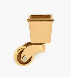 a gold toilet paper holder on a white background