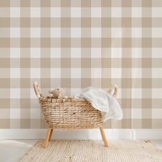 a wicker basket with two teddy bears in it sitting on a rug next to a wall