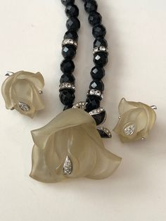 "Beautiful designer jewelry set from the late 70s/early 80s signed DVF for Diane Von Furstenberg. The set includes a beautiful beaded necklace made of faceted black glass beads called French Jet accented with clear rhinestone rondelles and a focal point of a frosted Lucite rose with rhinestone accents. The necklace measures 15\" long and ends in a spring ring clasp. The frosted Lucite rose measures 1.5\" by 1.5\" and is also accented with metal leaves, black enameled and set with clear rhineston Beautiful Beaded Necklaces, Vintage Jewelry Antique, Lucite Jewelry, Liquid Silver, Jewelry Antique, Metal Leaves, Amber Jewelry, Lampwork Glass Beads, Rhinestone Bracelet