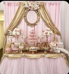 a pink and gold dessert table with lots of food on it's tablescape