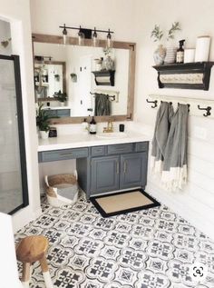 a bathroom with black and white tile flooring