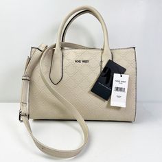 Beautiful Beige Nine West Handbag Completely New And With Its Tags. It Can Be Used For Casual Activities And With The Functionality That You Can Use It With Or Without Its Straps As You Feel More Comfortable. This Nine West Handbag Has: - Top Handles For Easy Transport. - One Top Zippered Closure. - Snap Top Closure To Secure Items. - Lined And Spacious Interior. Measurements: Depth: 5 Inches Height: 8 Inches Length: 12 Inches Strap Length: 51 1 2 Inches Weight: 1 Lb. And 10 Onz. Look At The Pho Nine West Handbags, Interior Measurements, Beige Handbags, Nine West Bags, Over The Shoulder Bags, Faux Leather Bag, White Purses, Celine Luggage Bag, Large Shoulder Bags