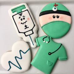 three decorated cookies in the shape of medical equipment