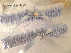 Wedding garter set . One to keep , one to throw. Classic blue garters for the tradition of something blue. Made with lingerie elastic for comfort . Elegant keepsake garter edged with white lace and blue ribbon , throw garter satin band, embellished with blue ribbon bows . * Garters stretches to 55cm ,PM  your thigh measurement ,for  a custom fit  * Lace edged garter Width 5cm , 2 inches * Satin Band garter width 2 cm, 1"inches . Presented in organza  keepsake pouch for the Bride to be Blue Garter, Wedding Garter Set, Wedding Garter, Garter Set, Wedding Item, Garters, Wedding Basket, Lace Edging, Blue Ribbon