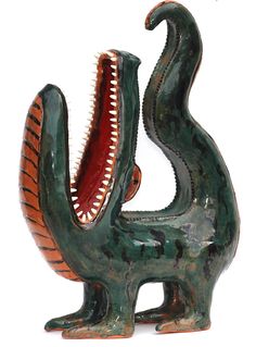 a ceramic sculpture of an animal with its mouth open