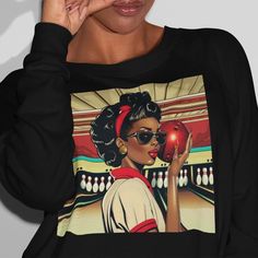 Celebrate your love for bowling and Afrocentric culture with this unique Woman Bowling Sweatshirt! Inspired by vintage pop art, this African American woman sweatshirt features a bold design of bowling alley pins, perfect for any bowling sports team.  Embrace retro vibes and make a statement on the lanes with this stylish and eye-catching sweatshirt that pays homage to the beauty of afrocentric culture. Stand out from the crowd and show off your passion for bowling in a truly one-of-a-kind way! Ideal for any situation, this heavy blend crewneck sweatshirt is pure comfort. Made from polyester and cotton, the collar is ribbed knit, so it retains its shape even after washing. There are no itchy side seams on these sweaters.  This sweatshirt feels cozy and is the perfect choice for those colder Retro Sweatshirt With Graphic Print In Relaxed Fit, Retro Sweatshirt For Sports Events, Black Retro Sweatshirt With Relaxed Fit, Retro Black Relaxed Fit Sweatshirt, Retro Custom Print Tops For Streetwear, Retro Black Sweatshirt With Screen Print, Pop Art Vintage, Retro Pop Art, Vintage Pop Art