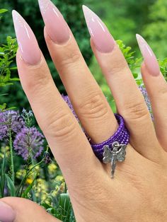 Discover the magic of our enchanting fairy charm ring, adorned with delicate purple beads. This whimsical piece adds a touch of fantasy and wonder to any outfit, making it the perfect accessory for fairy enthusiasts and those seeking unique jewelry. Benefits and Features: Unique and eye-catching design High-quality beads and resin Adds a touch of fantasy and wonder to any outfit Supports sustainable and handmade fashion Perfect gift for fairy enthusiasts or jewelry lovers Fairy charm Purple bead Fairy Ring, Fairy Charms, Charm Ring, Whimsical Jewelry, Purple Beads, Beaded Ring, Charm Rings, Outfit Making, Beaded Rings