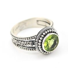 This genuine peridot round cut gemstone is set in a sterling silver bezel ring setting with bead word and coil work around the bezel. The band is composed of three graduating bands with bead work and scroll work. Ring is a size 6 and can be sized. Style Number: 19449 Metal: 925 Sterling Silver Gemstone: Genuine Peridot Dimensions: 1/2 inch wide Handmade in Bali, Indonesia Anniversary Round Peridot Gemstones, Formal Peridot Rings With Polished Finish, Silver Peridot Ring With Round Cut, Round Green Peridot Gemstones, Silver Peridot Rings With Polished Finish, Art Glass Jewelry, Bezel Ring, Peridot Ring, Amber Jewelry