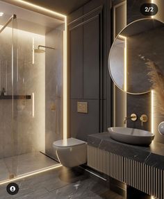 a bathroom with a sink, toilet and shower in it's own area that is lit up at night