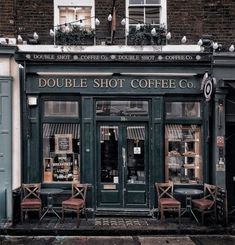 the outside of a coffee shop with tables and chairs