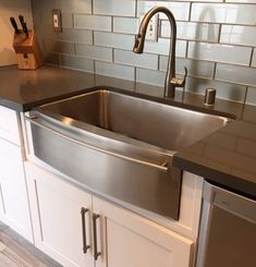 a stainless steel kitchen sink and dishwasher