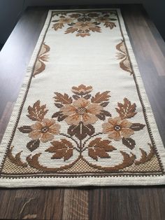 a white rug with brown flowers on it